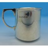 A silver mug with initials,