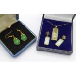 A pair of silver gilt and green stone earrings,
