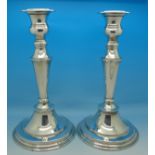 A pair of modern silver plated candlesticks,