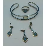 Silver and opal set jewellery; a bangle, earrings and matching pendant and a ring,