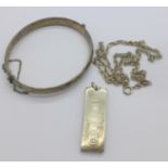 A silver ingot pendant and chain and a silver bangle,