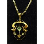A 9ct gold Art Nouveau pendant on a 9ct gold chain,