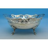 A pierced silver bowl on four feet,