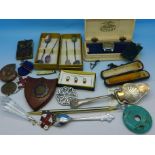 A Bakelite Rotary wristwatch box, Rolex spoon, gem set spoons, medallions, etc.