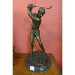 A bronze figure of a golfer,