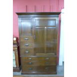 An Arts and Crafts oak wardrobe by Simpson & Sons,