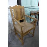 A Cotswold light oak armchair,