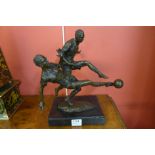 A bronze figure of two footballers,