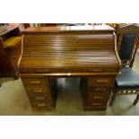 An early 20th Century oak tambour roll-top desk