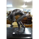 A bronze figure of a classical Greek male nude ,