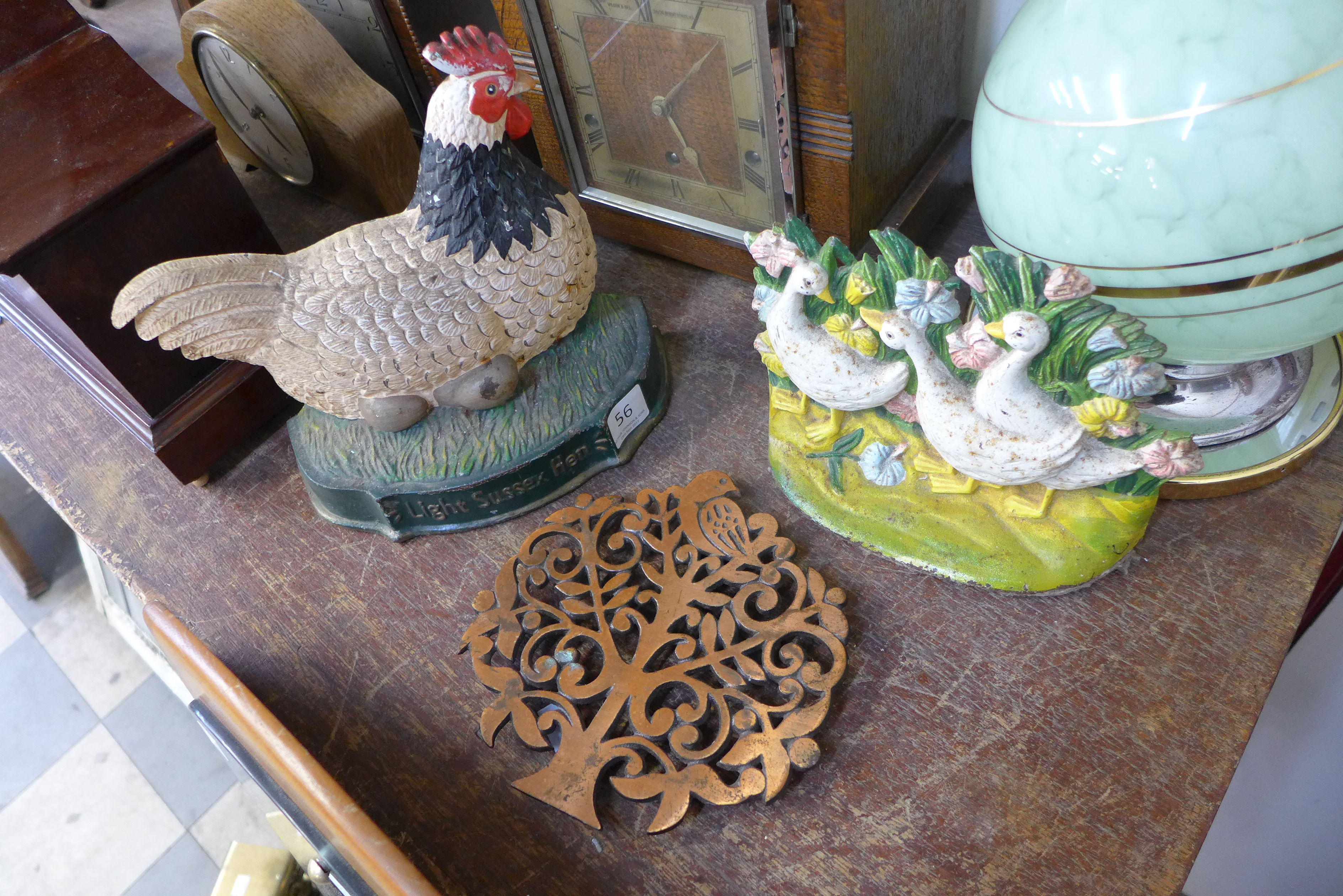 Two painted cast iron door stops and a steel wall plaque