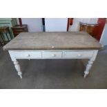 A Victorian painted pine three drawer kitchen table
