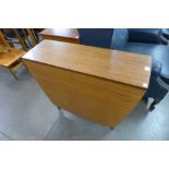 A teak drop-leaf table