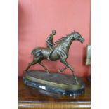 A large bronze figure of a jockey and racehorse,