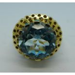 A 9ct gold ring set with a large blue topaz, 7.