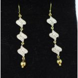 A pair of silver gilt earrings set with six diamonds