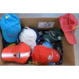 A large collection of Formula 1 baseball caps including Michael Schumacher and Lewis Hamilton and