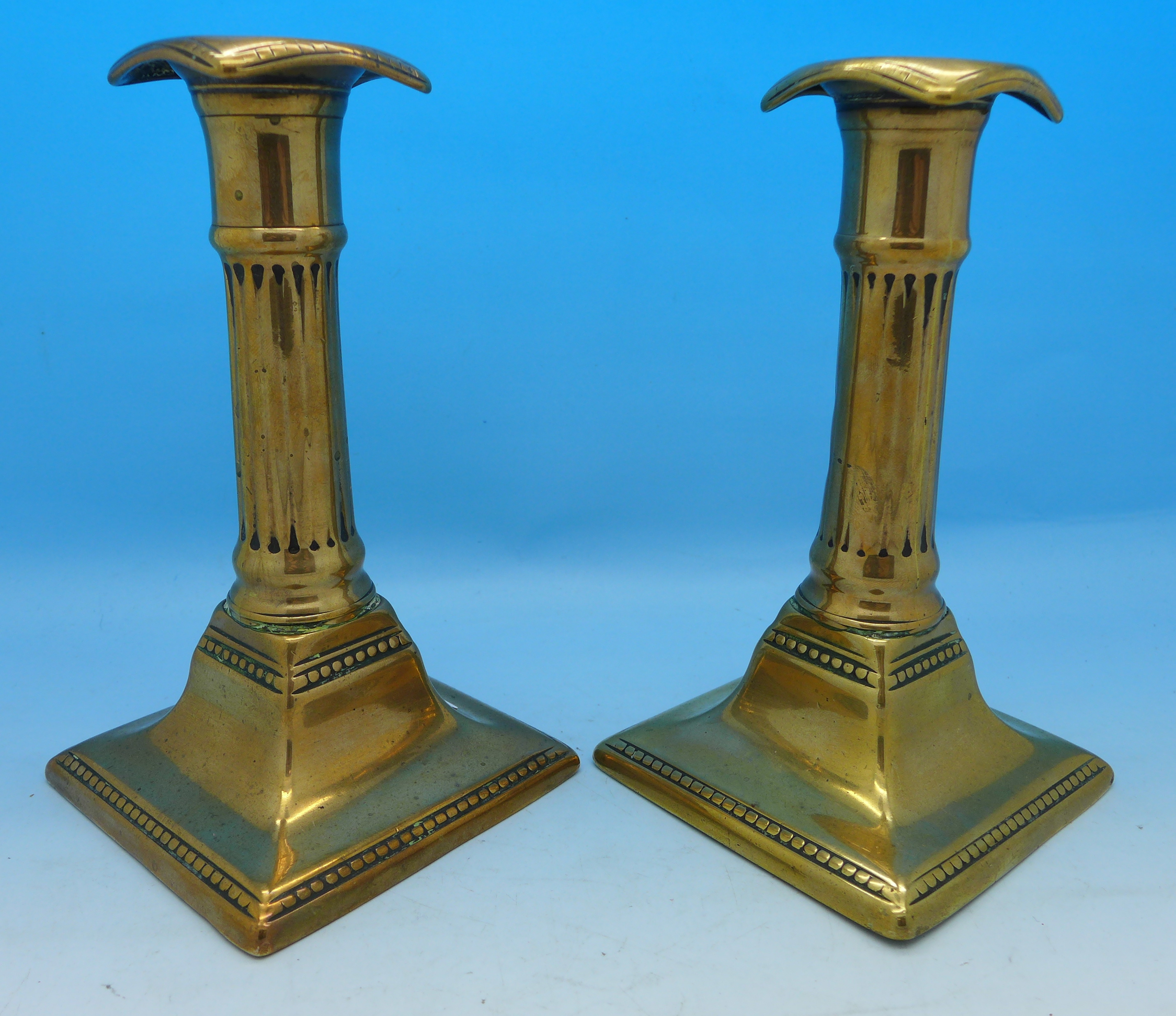 A pair of 19th Century patent brass candlesticks