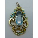 A yellow metal and blue stone pendant,