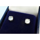 A pair of diamond ear studs, each stone approximately 0.