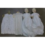 Two composite dolls and two silk christening dresses