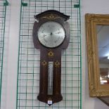 An Art Nouveau inlaid mahogany aneroid barometer