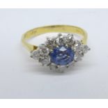 An 18ct gold, sapphire and diamond cluster ring, 0.60ct sapphire and 0.