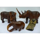 Two carved rhinoceros,