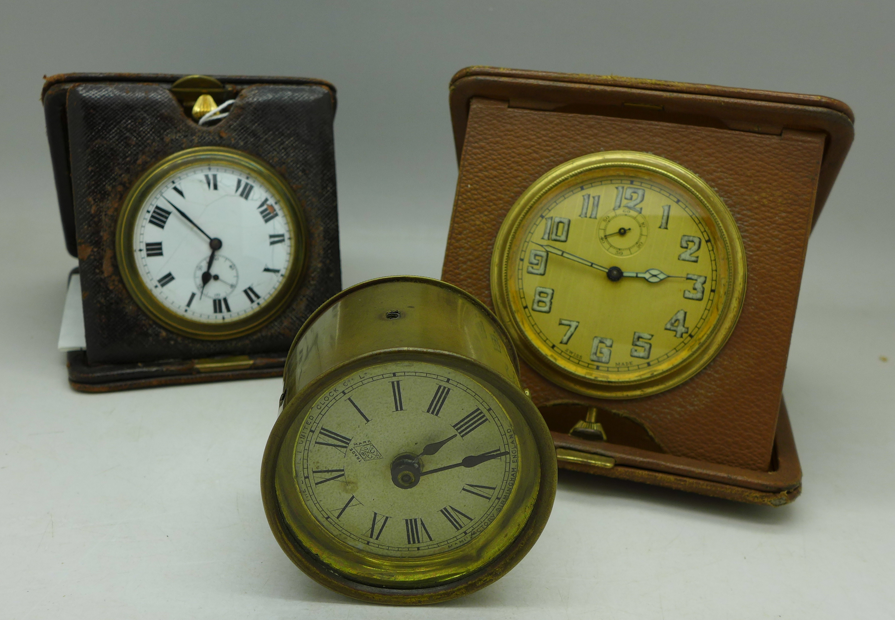 Two folding travel watches, one dial a/f and a British United Clock Company Ltd.