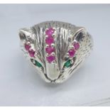 A silver cat ring set with rubies and emeralds,