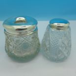 Two silver topped glass jars