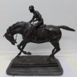 A cast metal figure of a horse and jockey, after Mene,
