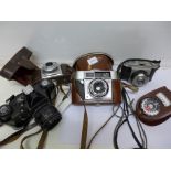 Four film cameras and a light meter including Zenit-E and two Agfa