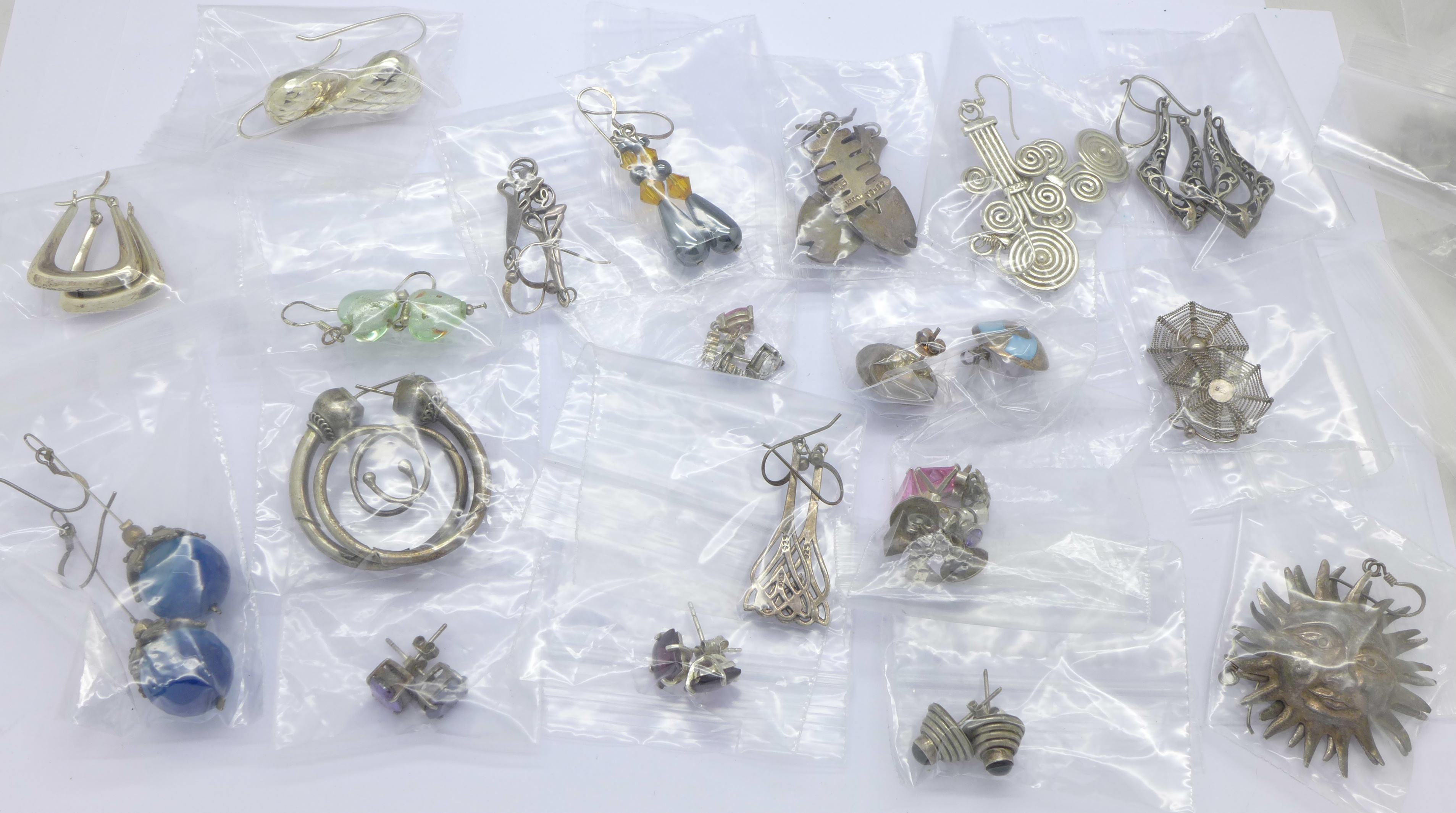 Thirty pairs of silver earrings