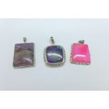 Three large silver stone set pendants,