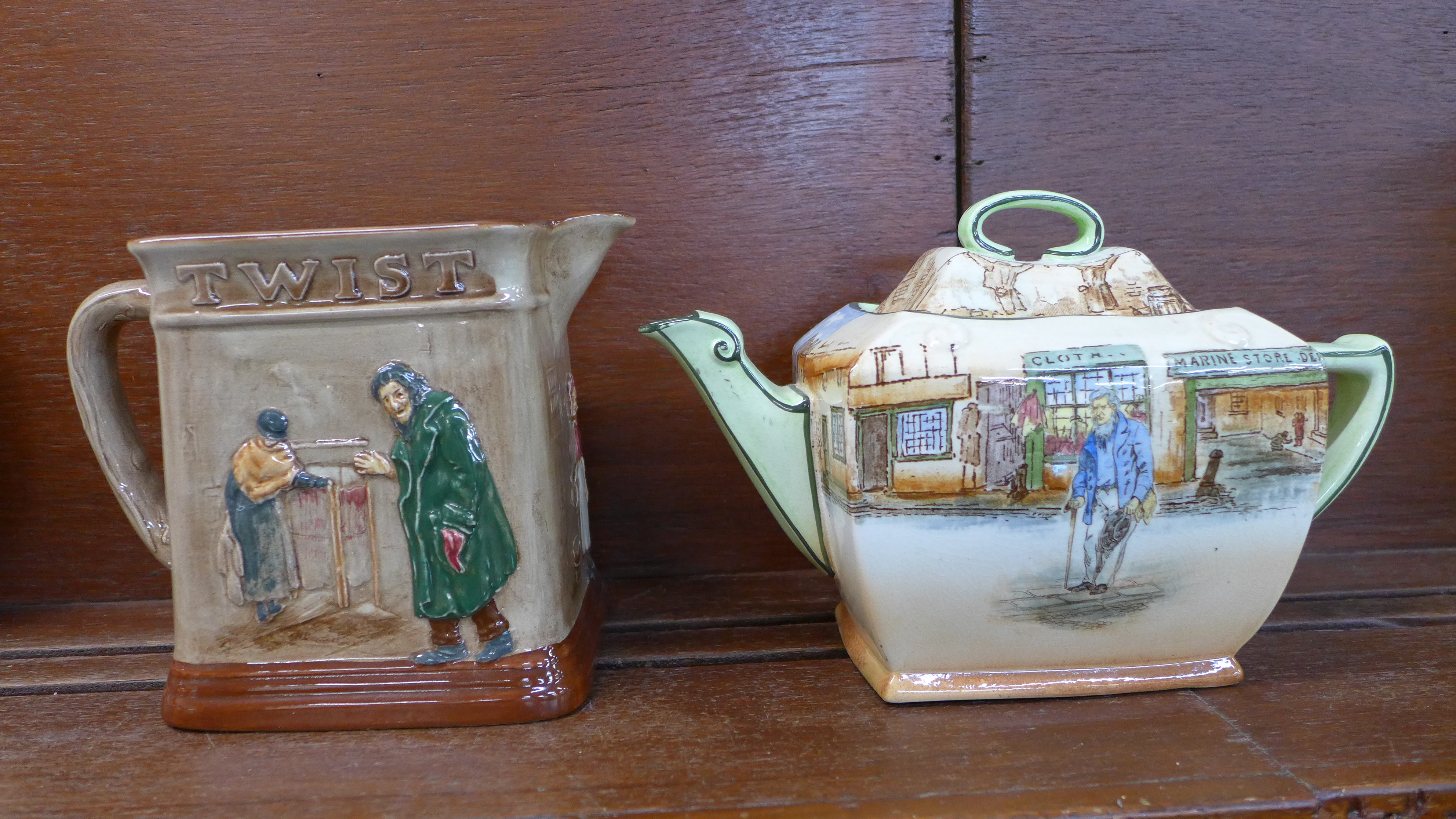 A Royal Doulton Dickens Series ware teapot and lid and a relief moulded 'Oliver Asks For More' jug