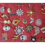 A collection of twenty-five costume brooches