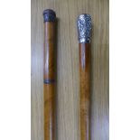 Two malacca walking canes, one with white metal top,