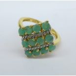 A silver gilt and emerald ring,