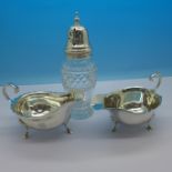 Two silver sauce boats and a silver topped shaker,