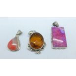 Three silver stone set pendants