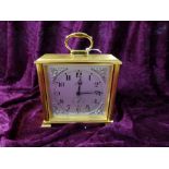 An Imhof brass cased mantel clock with swing out dial