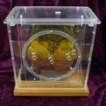 A mantel clock with chiming movement in a perspex case