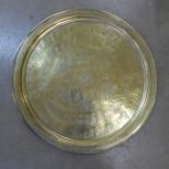 A large circular brass tray