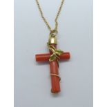 A yellow metal and coral pendant on a fine 9ct gold chain