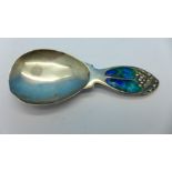 A silver and enamel Art Nouveau caddy spoon, Birmingham 1911, William Hair Haseler,
