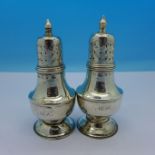 A pair of Victorian silver pepperettes,