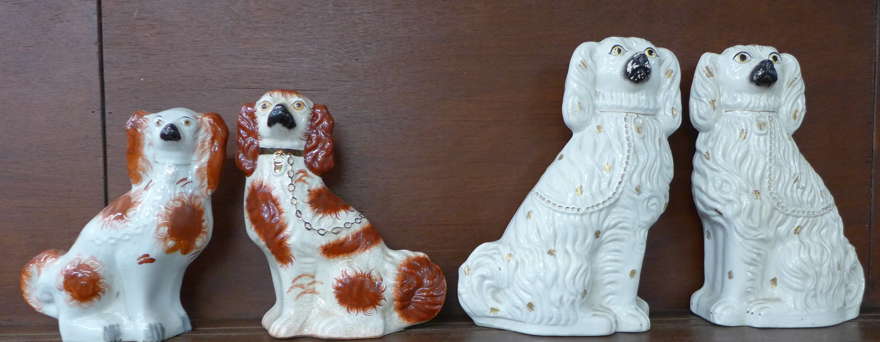 A pair of large Staffordshire spaniels and two matched Staffordshire spaniels,
