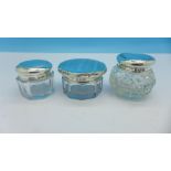 Three small silver topped glass jars