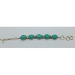 A silver and turquoise bracelet